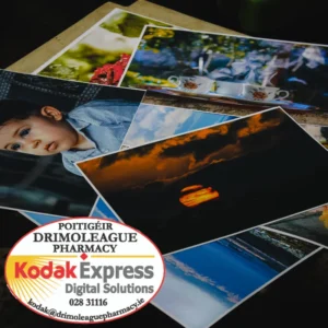 Some printed photos layed in a pile. Photo printing and passport photo printing available here.